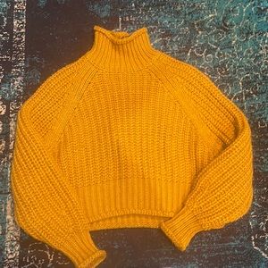 Knit pattern mustard colored sweater.